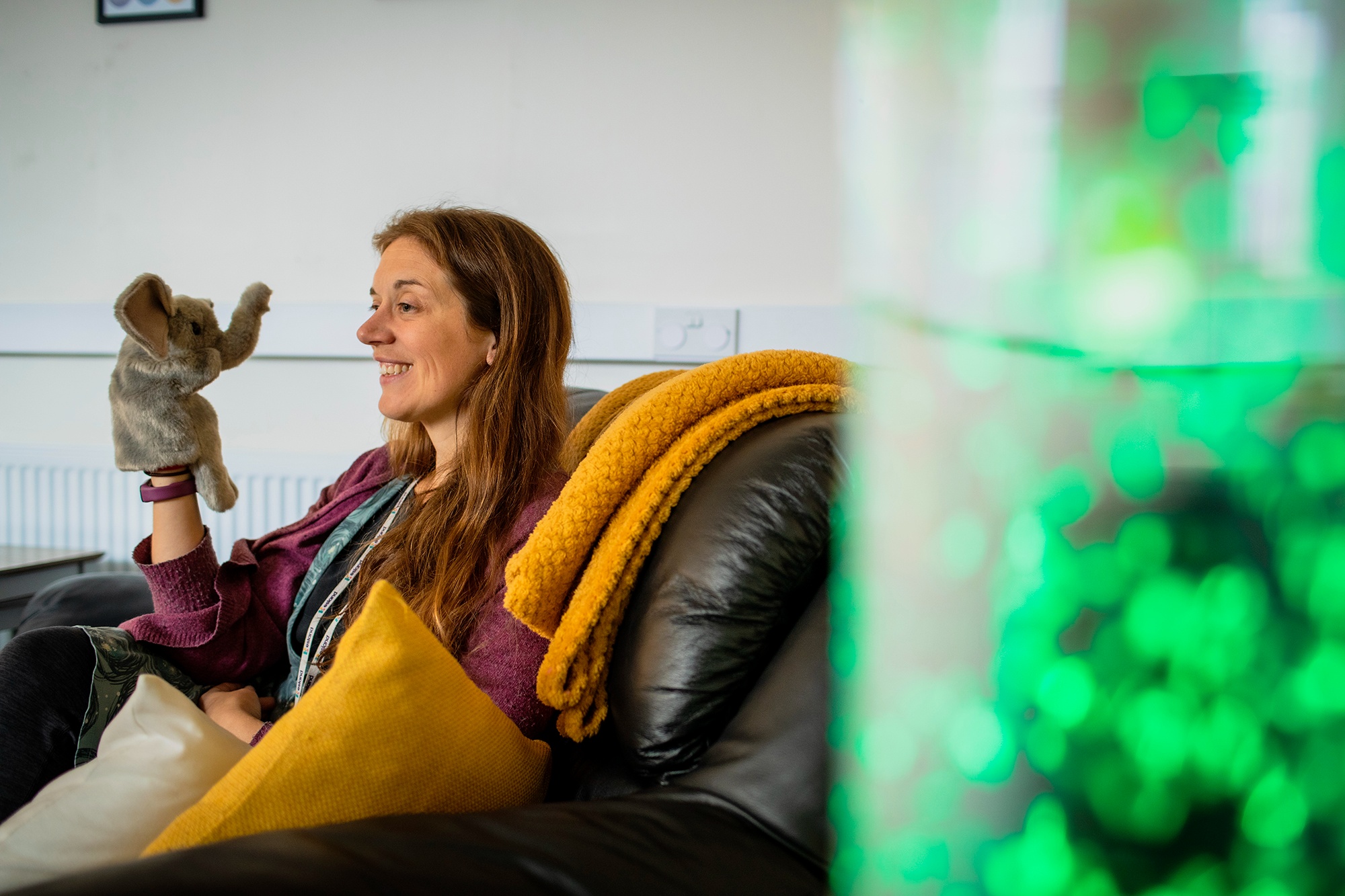 Image of teacher holding elephant hand puppet