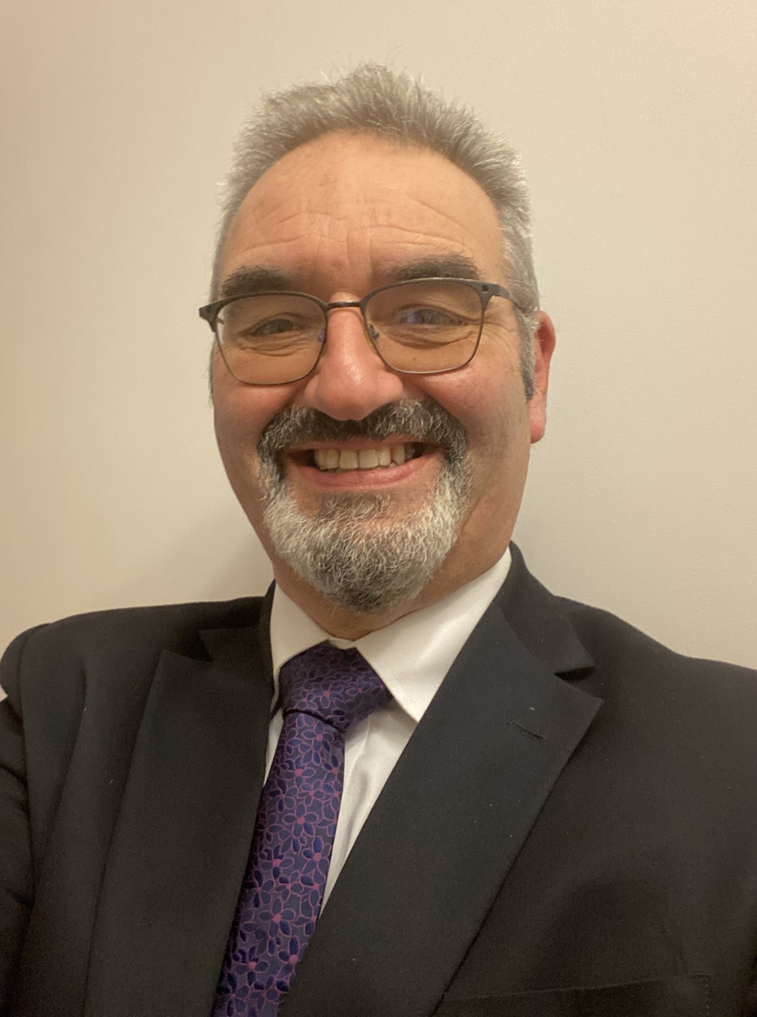 Image of a man wearing spectacles smiling